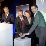 The Premier of Tasmanian David Bartlett, the Prime Minister and the Minister for Broadband, Communications and the Digital Economy press a blue button to officially launch the NBN Tasmania network.