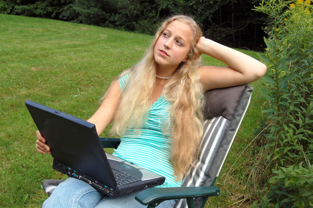 Female student outdoors with computer