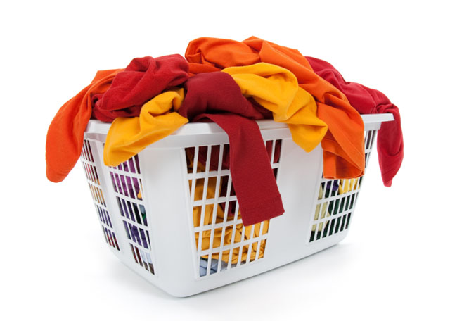 Bright clothes in laundry basket. Red, orange, yellow.